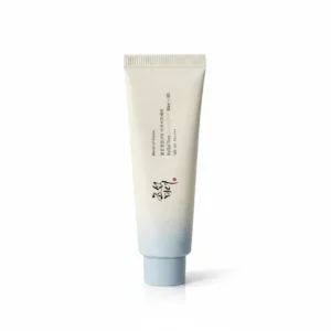 A white bottle with a blue and gold label, containing Beauty of Joseon Radiance Sunscreen SPF 50+.