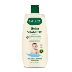 A 250ml bottle of BioLuxe Aloe Vera & Vitamin E Baby Shampoo with a white label and green accents