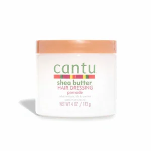 A 113g jar of Cantu Shea Butter Hair Dressing Pomade. The jar has a yellow label with the Cantu logo and product name.