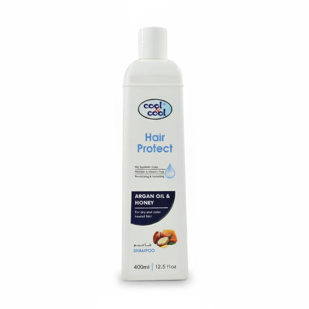 A white bottle of Cool & Cool Adult Hair Shampoo with a green and blue label. The label displays the product name and key ingredients like Shea Butter and Biotin.