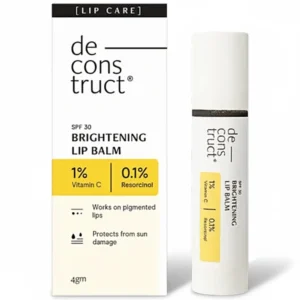 A round, white lip balm tube with the De-construct logo and 'Brightening Lip Balm SPF 30' printed on the label