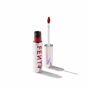 A bottle of FENTY Velvet Liquid Lipstick in a deep red shade, with the FENTY logo and product name printed on the label.