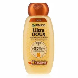 A bottle of Garniger Ultra Doux Replenishing Shampoo with a white and green label. The bottle contains 400ml of product.