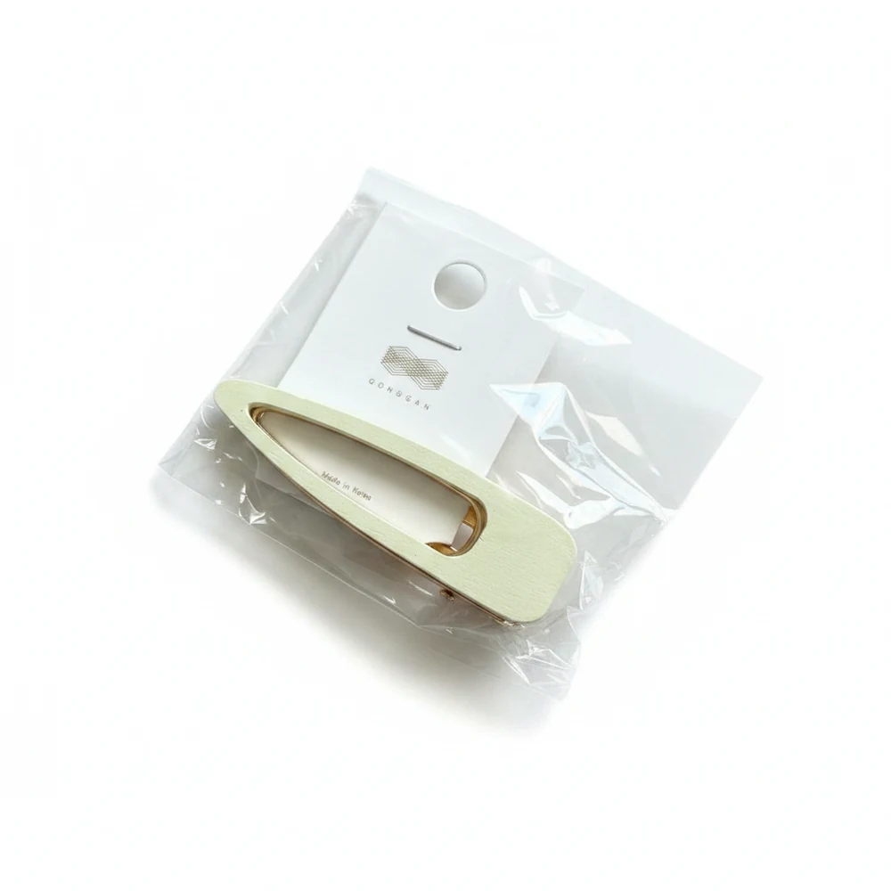 Assorted metal hair clips in various sizes and shapes, including round, oval, and rectangular designs in silver, gold, and black colors