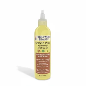 A clear glass bottle with a black cap, containing a golden-colored hair oil. The label displays the Hollywood Beauty brand name and product name.