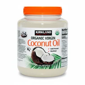 A clear glass bottle with a white label containing Kirkland Organic Virgin Coconut Oil. The label has the Kirkland logo and states the product is 2.48L in size.