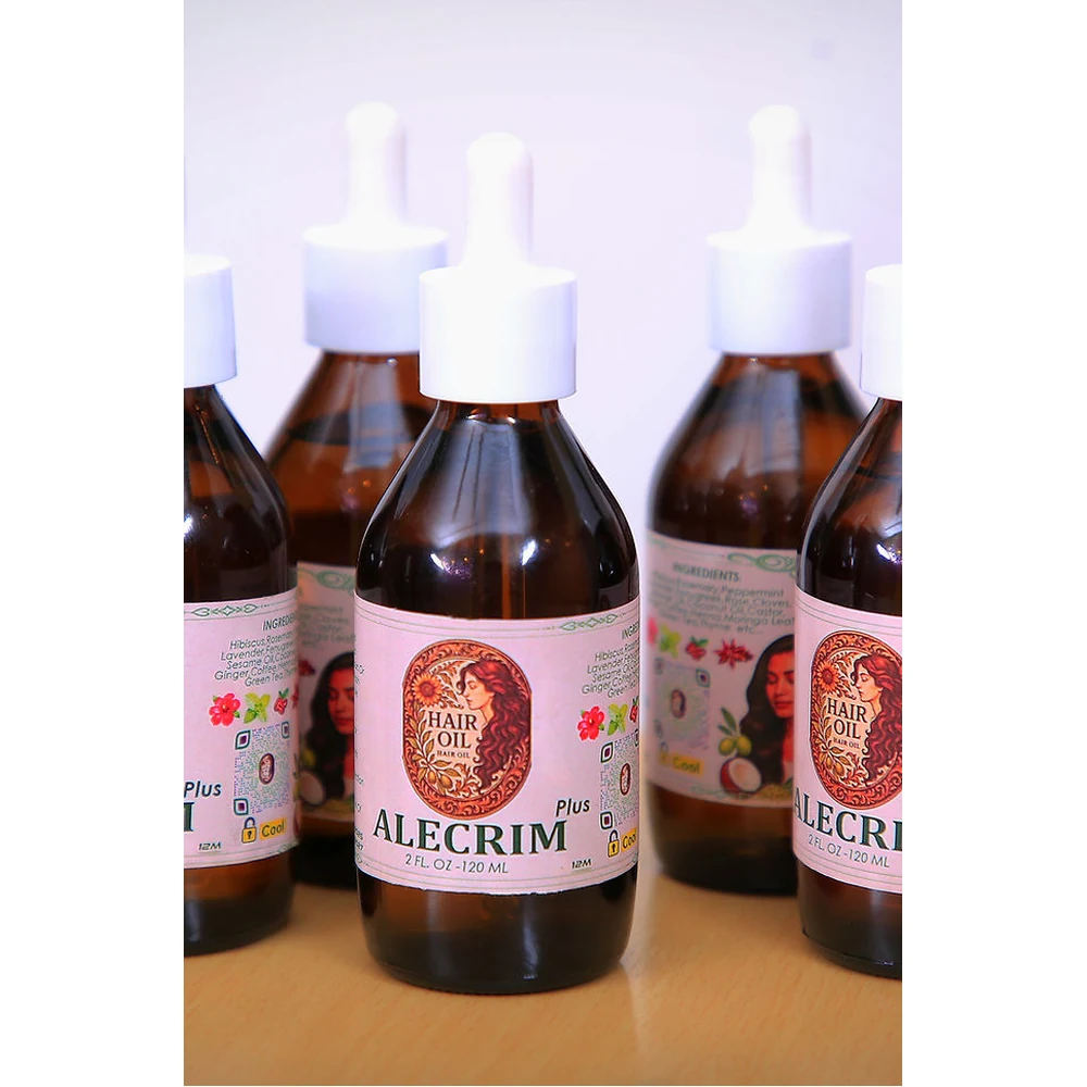A bottle of Alecrim Rosemary Hair Oil with a green and white label. The bottle is clear, showing the amber-colored oil inside.