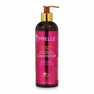 A bottle of Mielle Pomegranate & Honey Conditioner with a light pink label and a pump dispenser. The label features the Mielle logo and prominently displays the 'Pomegranate & Honey' ingredients.