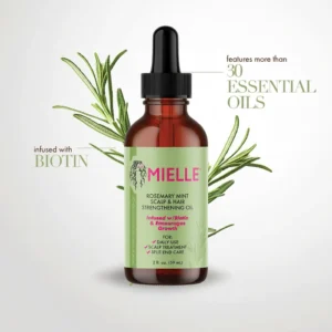 A bottle of Mielle Rosemary Mint Scalp & Hair Strengthening Oil. The bottle has a green and white label with the Mielle logo and product name. The oil appears to be a light amber color.