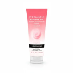 A 100g bottle of Neutrogena Pink Grapefruit Acne Face Wash. The bottle has a pink and white label with the Neutrogena logo and product name.