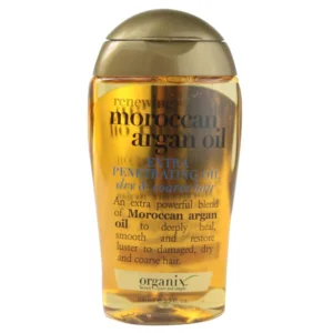 A clear glass bottle with a white and gold label, containing a golden-colored argan oil hair treatment product.