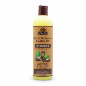 A bottle of OKAY Black Jamaican Castor Oil Shampoo with a black label and text describing the product.