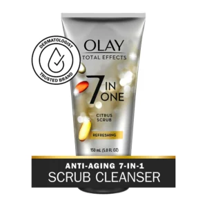 A bottle of Olay 7 in 1 Refreshing Citrus Scrub, with a white and orange label. The bottle has a pump dispenser and contains 150 ml of product.