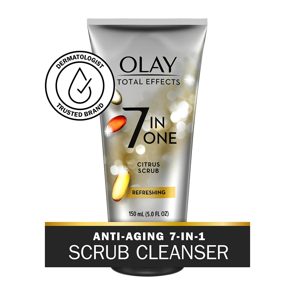 A bottle of Olay 7 in 1 Refreshing Citrus Scrub, with a white and orange label. The bottle has a pump dispenser and contains 150 ml of product.