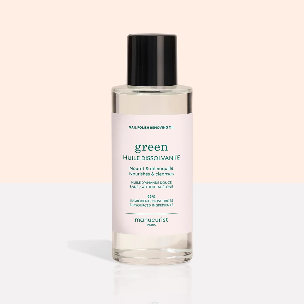 A green glass bottle of Perfect Cosmetics Nail Polish Remover with a white label displaying the brand name and product details.