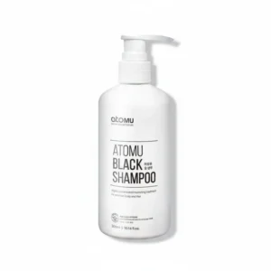 A black bottle of Atomou Black Shampoo with a label showing the brand name and product details.