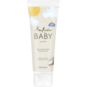 A white tube of SheaMoisture Baby Lotion with a green label featuring the SheaMoisture logo and images of coconut and murumuru butter.