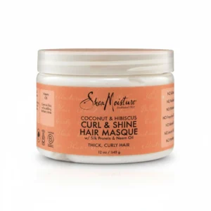 A round, white jar with a green label featuring the SheaMoisture logo and the product name 'Coconut & Hibiscus Curl & Shine Hair Masque' in green and white text.