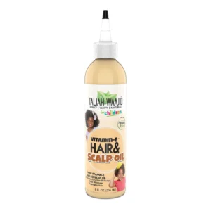 A bottle of Taliah Waajid Children Hair Oil with a green and white label. The bottle has a pump dispenser top.