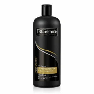 A bottle of Tresemme Replenishing Shampoo with Avocado & Coconut, 828ml. The bottle has a purple and white label with the Tresemme logo.