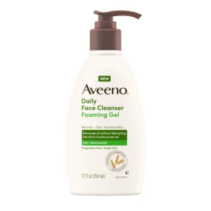 A white bottle with the Aveeno logo and label, containing a foaming facial cleanser.