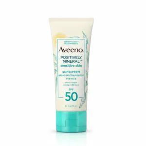 A white bottle of Aveeno Positively Mineral Sunscreen Lotion with a green label. The bottle has a pump dispenser and displays the SPF 50 sun protection claim.