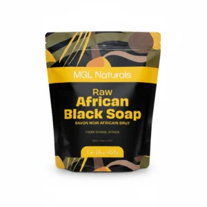 A round bar of dark brown/black African black soap with a textured surface, wrapped in a green and white label