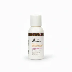 A white bottle with a green label, containing a thick, creamy white shea butter body lotion.