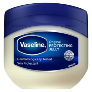A white jar with a blue label, containing a clear, glossy petroleum jelly product.