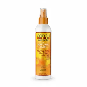 A bottle of Cantu Shea Butter Coconut Oil Shine & Hold Mist. The bottle is white with a green label and cap, and the product name is displayed prominently.