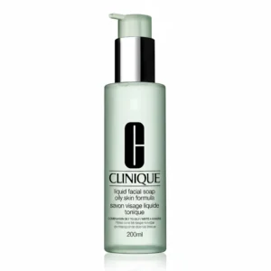A clear glass bottle with a light blue label that says 'Clinique Liquid Facial Soap Mild'. The bottle contains a clear liquid facial soap.
